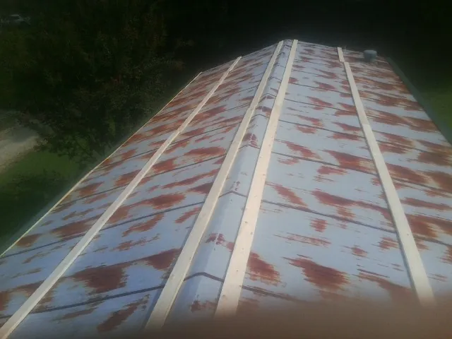 Rusted metal roof panels with new wood purlins before replacement — Storm Damage Roof Repair in Madera by Roofing Brothers